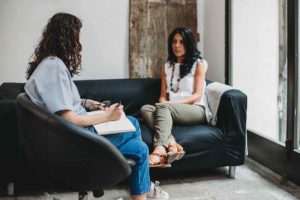 two women discussing outpatient addiction treatment