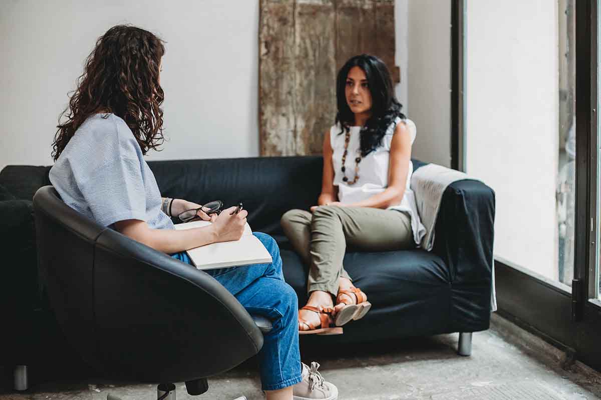 two women discussing outpatient addiction treatment