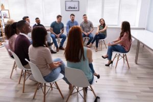 people sitting in a group counseling program